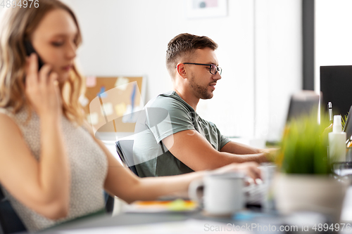 Image of man in glasses with computer working at office