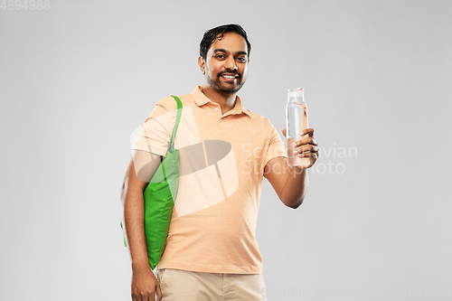 Image of man with bag for food shopping and glass bottle