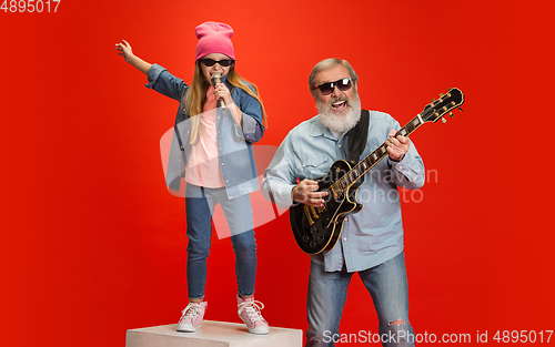 Image of Senior man, grandfather having fun and spending time together with girl, granddaughter. Joyful elderly lifestyle concept