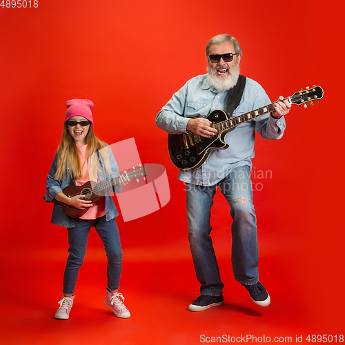 Image of Senior man, grandfather having fun and spending time together with girl, granddaughter. Joyful elderly lifestyle concept