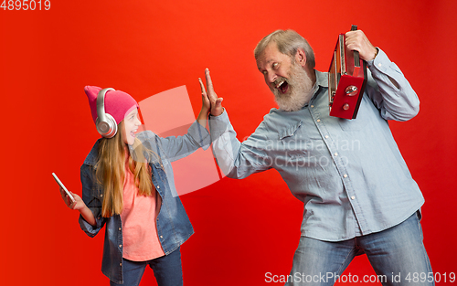 Image of Senior man, grandfather having fun and spending time together with girl, granddaughter. Joyful elderly lifestyle concept