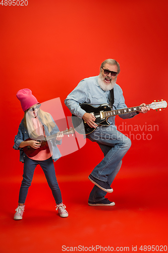 Image of Senior man, grandfather having fun and spending time together with girl, granddaughter. Joyful elderly lifestyle concept
