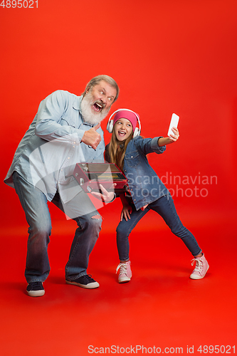 Image of Senior man, grandfather having fun and spending time together with girl, granddaughter. Joyful elderly lifestyle concept
