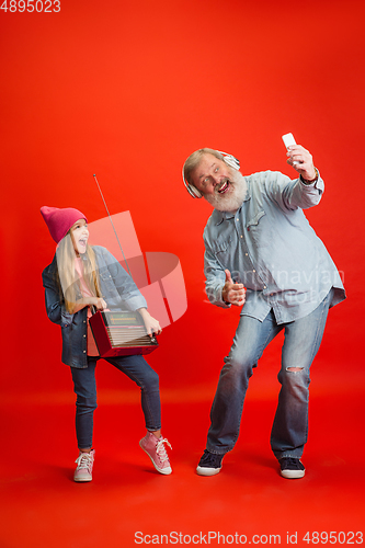Image of Senior man, grandfather having fun and spending time together with girl, granddaughter. Joyful elderly lifestyle concept