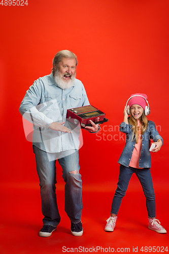 Image of Senior man, grandfather having fun and spending time together with girl, granddaughter. Joyful elderly lifestyle concept