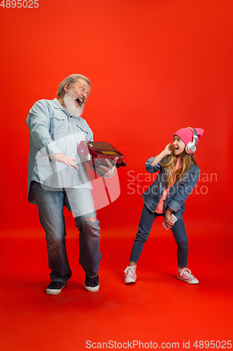 Image of Senior man, grandfather having fun and spending time together with girl, granddaughter. Joyful elderly lifestyle concept