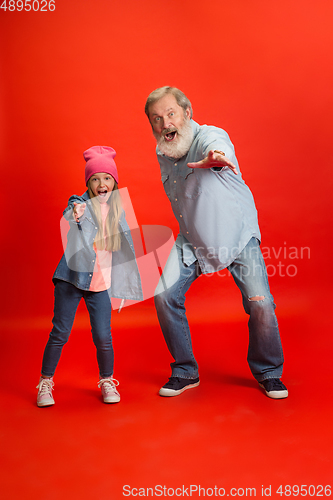 Image of Senior man, grandfather having fun and spending time together with girl, granddaughter. Joyful elderly lifestyle concept