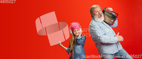 Image of Senior man, grandfather having fun and spending time together with girl, granddaughter. Joyful elderly lifestyle concept