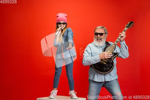 Image of Senior man, grandfather having fun and spending time together with girl, granddaughter. Joyful elderly lifestyle concept