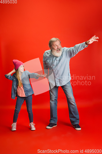 Image of Senior man, grandfather having fun and spending time together with girl, granddaughter. Joyful elderly lifestyle concept