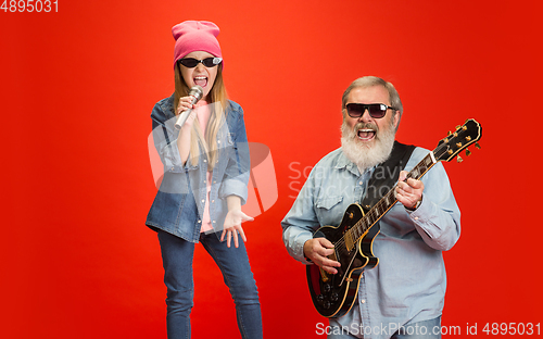 Image of Senior man, grandfather having fun and spending time together with girl, granddaughter. Joyful elderly lifestyle concept