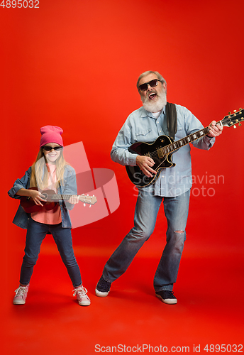 Image of Senior man, grandfather having fun and spending time together with girl, granddaughter. Joyful elderly lifestyle concept