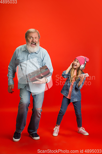 Image of Senior man, grandfather having fun and spending time together with girl, granddaughter. Joyful elderly lifestyle concept