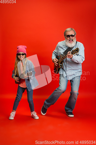 Image of Senior man, grandfather having fun and spending time together with girl, granddaughter. Joyful elderly lifestyle concept