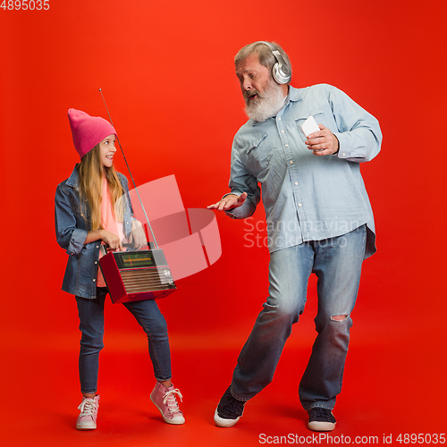 Image of Senior man, grandfather having fun and spending time together with girl, granddaughter. Joyful elderly lifestyle concept