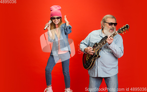 Image of Senior man, grandfather having fun and spending time together with girl, granddaughter. Joyful elderly lifestyle concept