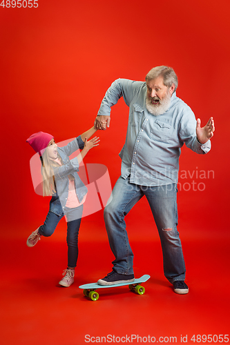 Image of Senior man, grandfather having fun and spending time together with girl, granddaughter. Joyful elderly lifestyle concept