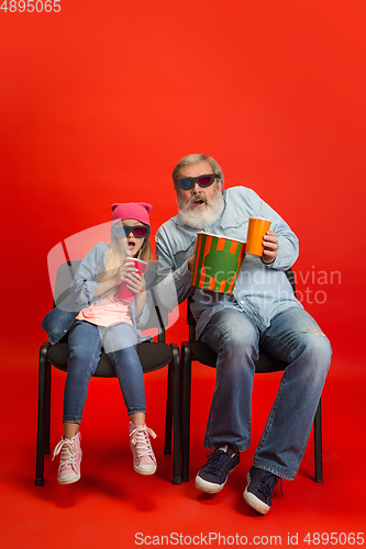 Image of Senior man, grandfather having fun and spending time together with girl, granddaughter. Joyful elderly lifestyle concept