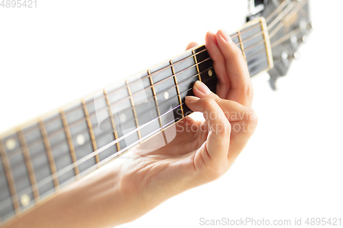 Image of Close up of guitarist hand playing guitar, copyspace, macro shot