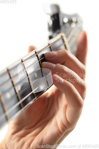 Image of Close up of guitarist hand playing guitar, copyspace, macro shot