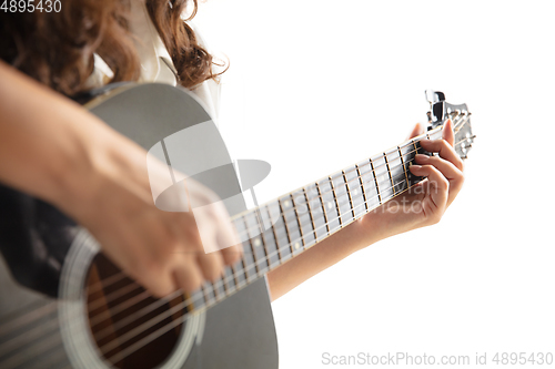 Image of Close up of guitarist hand playing guitar, copyspace, macro shot