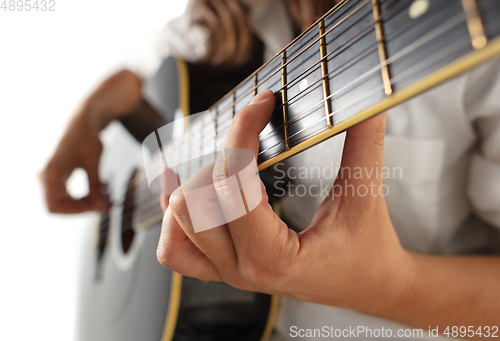 Image of Close up of guitarist hand playing guitar, copyspace, macro shot