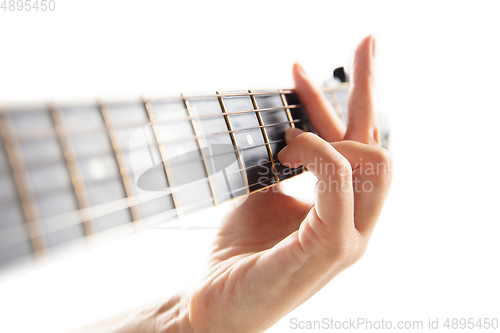 Image of Close up of guitarist hand playing guitar, copyspace, macro shot