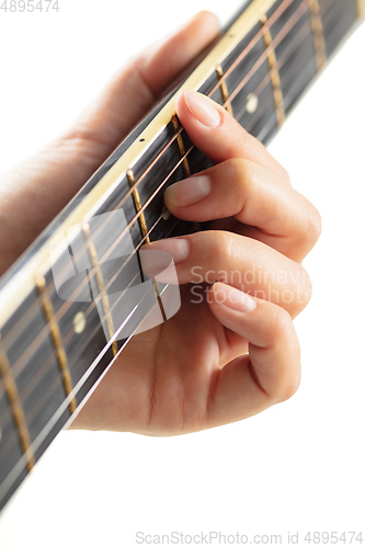 Image of Close up of guitarist hand playing guitar, copyspace, macro shot