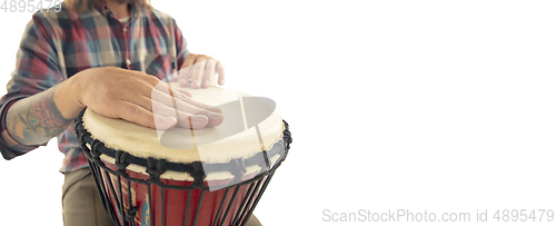 Image of Man plays ethnic drum darbuka percussion, close up musician isolated on white studio background