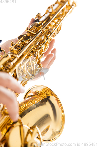 Image of Close up woman playing saxophone isolated on white studio background