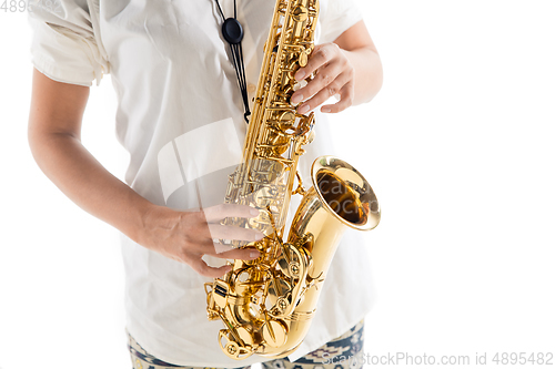 Image of Close up woman playing saxophone isolated on white studio background