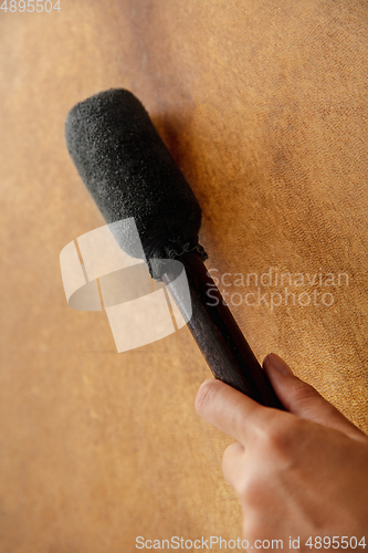 Image of A close up of hands playing the tambourine, percussion on white studio background