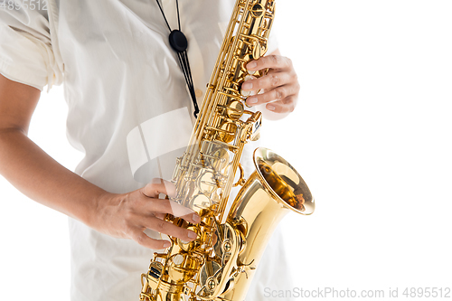 Image of Close up woman playing saxophone isolated on white studio background