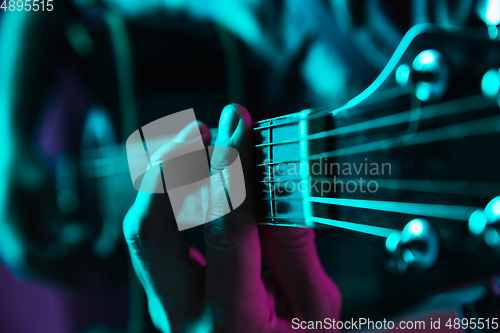 Image of Close up of guitarist hand playing guitar, copyspace, macro shot