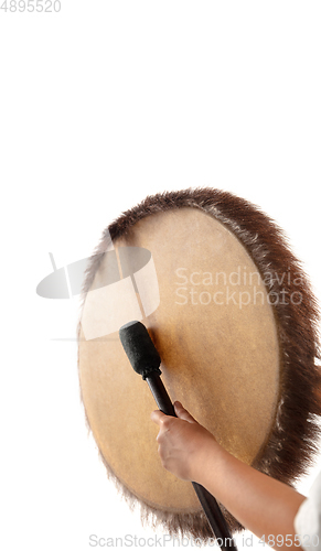 Image of A close up of hands playing the tambourine, percussion on white studio background