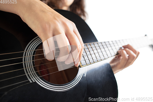 Image of Close up of guitarist hand playing guitar, copyspace, macro shot