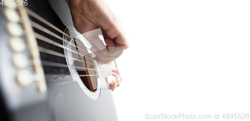 Image of Close up of guitarist hand playing guitar, copyspace, macro shot