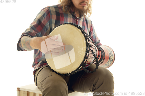 Image of Man plays ethnic drum darbuka percussion, close up musician isolated on white studio background