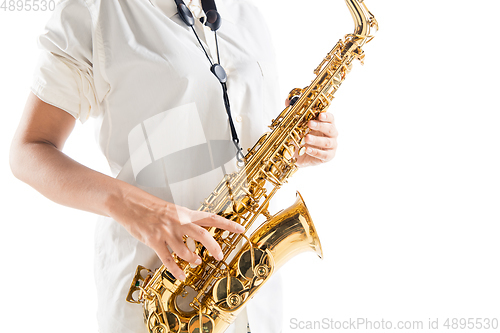 Image of Close up woman playing saxophone isolated on white studio background