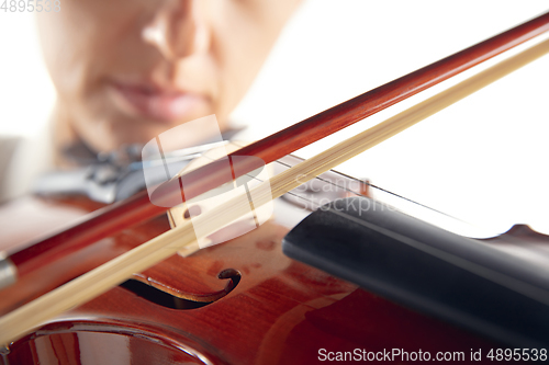 Image of Close up woman playing violin isolated on white studio background