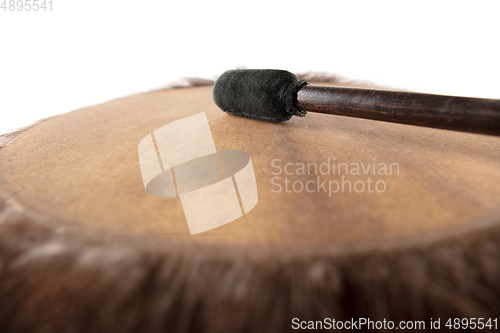 Image of A close up of hands playing the tambourine, percussion on white studio background