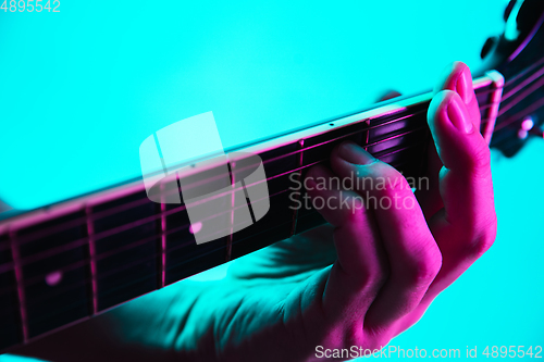 Image of Close up of guitarist hand playing guitar, copyspace, macro shot