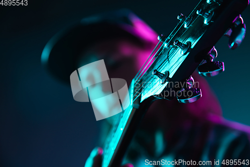 Image of Close up of guitarist hand playing guitar, copyspace, macro shot