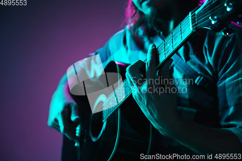 Image of Close up of guitarist hand playing guitar, copyspace, macro shot