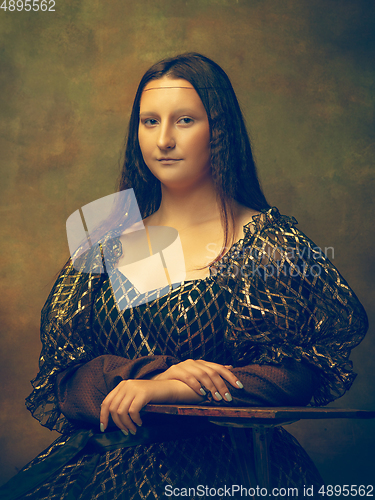 Image of Young woman as Mona Lisa on dark background. Retro style, comparison of eras concept.
