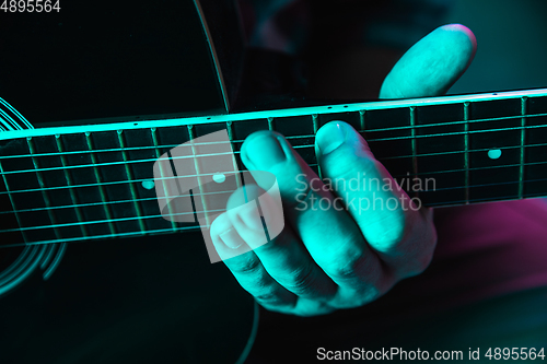 Image of Close up of guitarist hand playing guitar, copyspace, macro shot