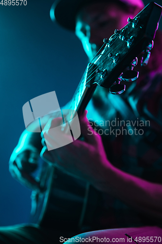 Image of Close up of guitarist hand playing guitar, copyspace, macro shot