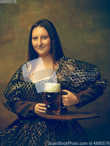 Image of Young woman as Mona Lisa on dark background. Retro style, comparison of eras concept.