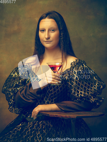 Image of Young woman as Mona Lisa on dark background. Retro style, comparison of eras concept.