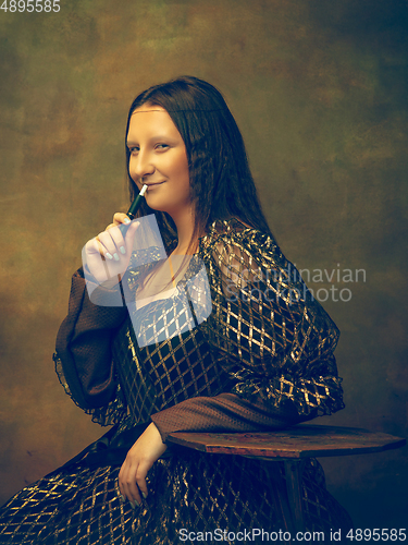 Image of Young woman as Mona Lisa on dark background. Retro style, comparison of eras concept.